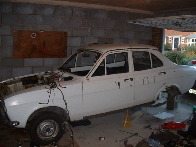 A beautiful car being ripped apart. And some joker has written 'tit' on the side with an angle grinder. No respect....