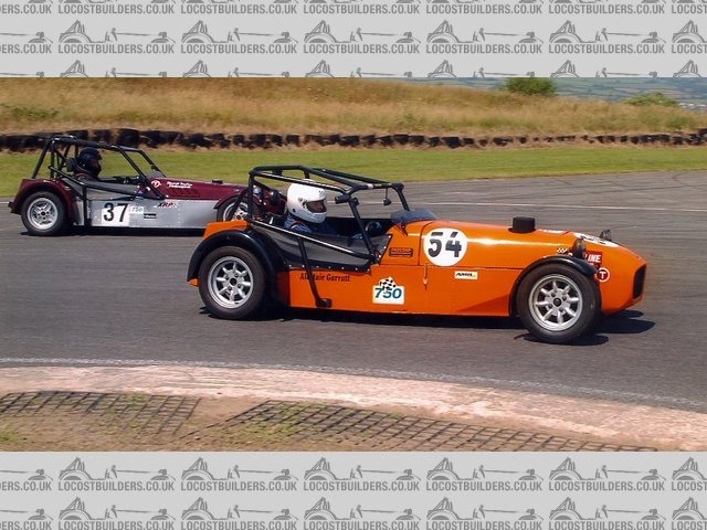 Alli nipping up the inside of Kev Lucas at pembrey hairpin